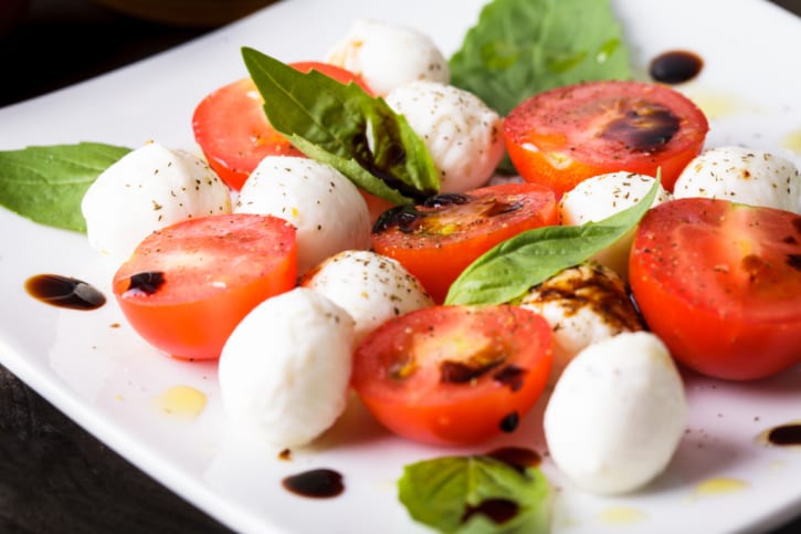 Caprese: cherry tomato, mozzarella balls and basil leaves.