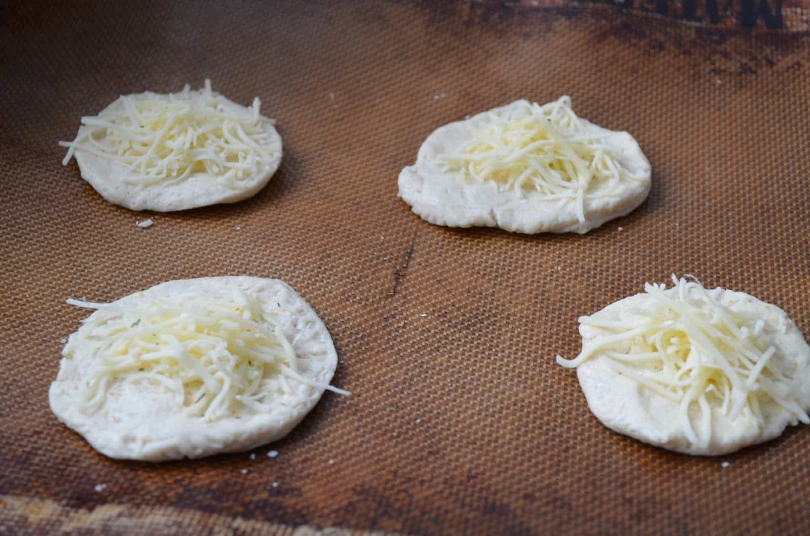 making garlic cheese bites with biscuit dough