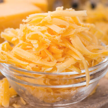 Bowl of grated Cheddar Cheese