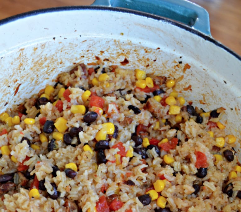 This Easy Mexican Rice Casserole Recipe with Black Beans, Sausage and Corn is an easy-to-make one-pot dish that goes from stovetop to oven.