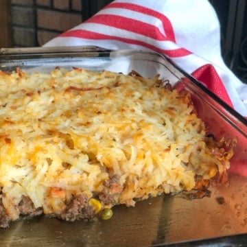 Hamburger Hashbrown Casserole with Vegetables and Cheese in Glass Baking Dish