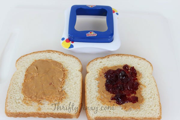 making homemade uncrustables with peanut butter and jelly