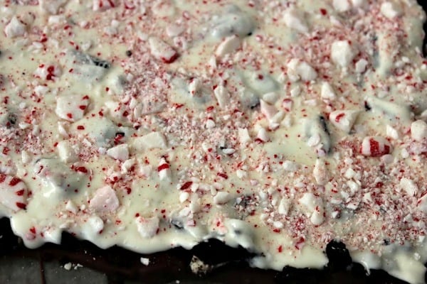 Adding crushed peppermint candies to Oreo Peppermint Bark