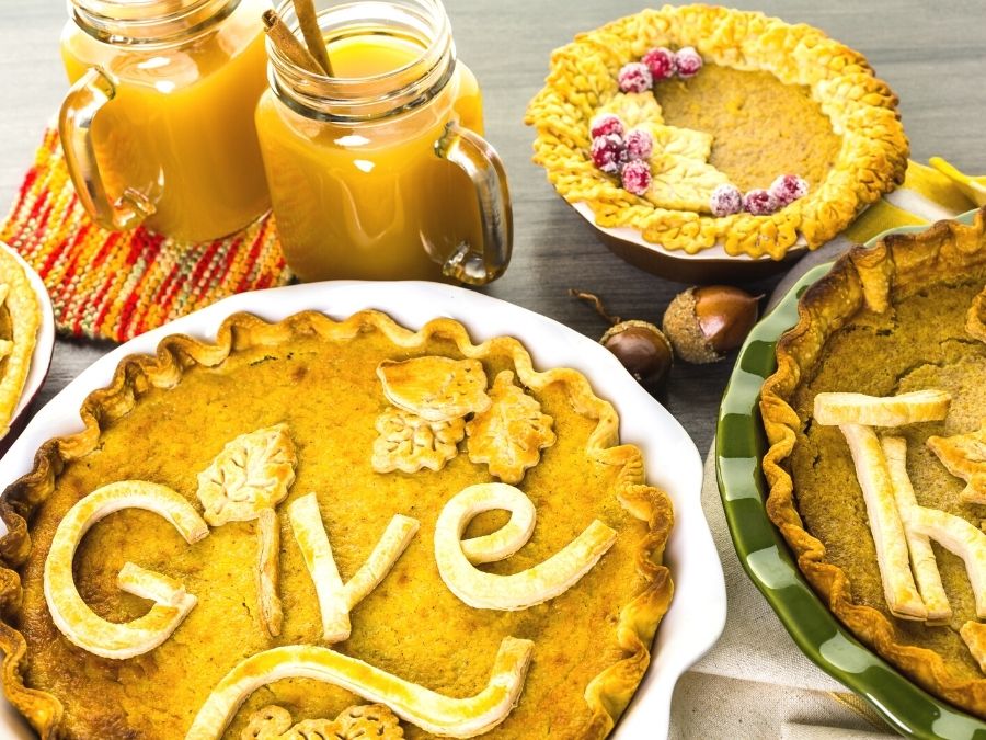 Pumpkin Pies and apple cider with cinnamon sticks