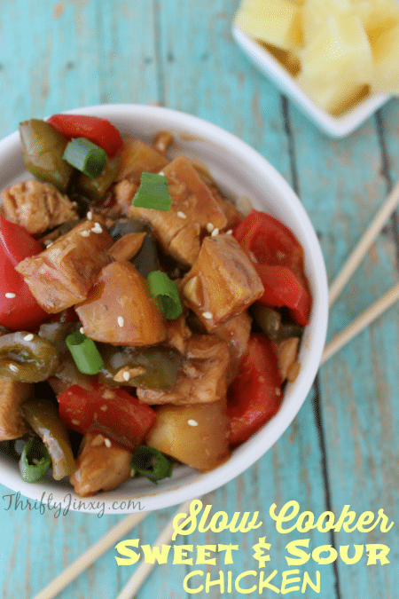 sweet and sour chicken in bowl with chopsticks and pineapple on side