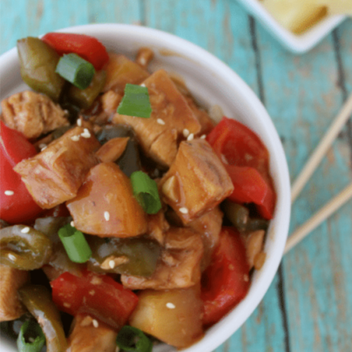 sweet and sour chicken in bowl with chopsticks