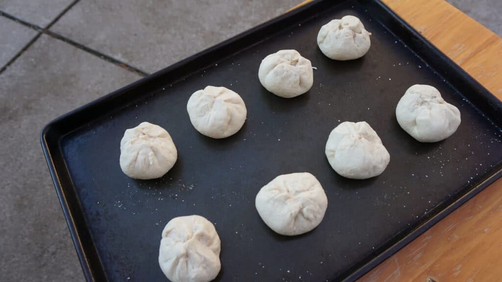 Forming Garlic Cheese Bombs from Biscuit Dough