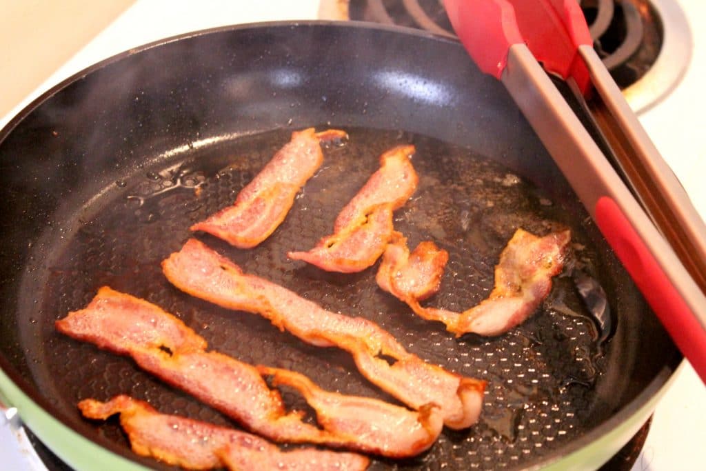 cooking bacon in frying pan