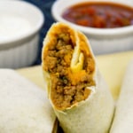 baked beef and cheese chimichanga with beans