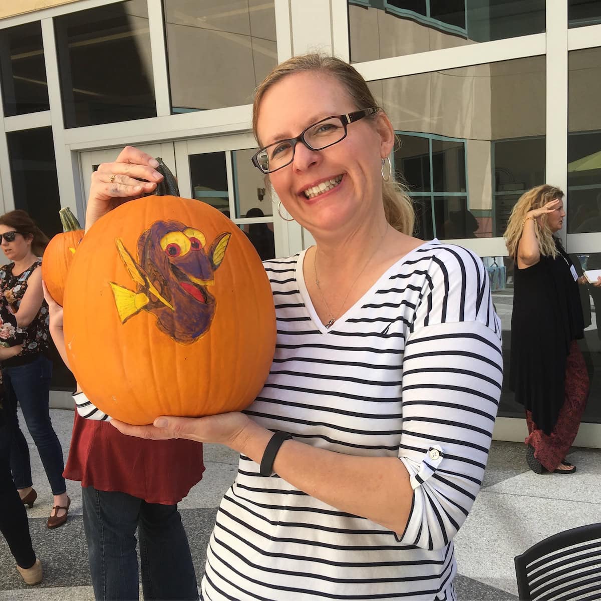 Woman holding Finding Dory Pumpkin Painted with Stencil.