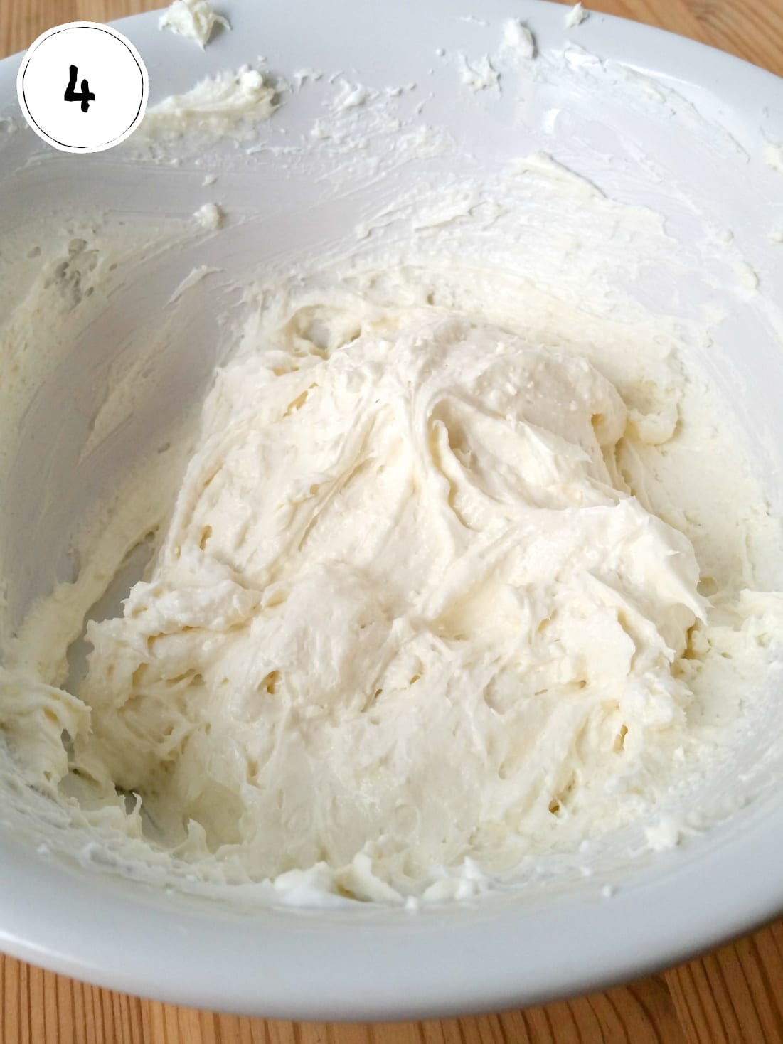 Sugar, cream cheese and whipped topping mixed in bowl.