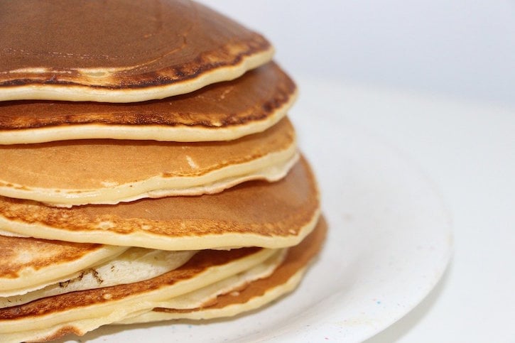 Stack of Pancakes on white plate.