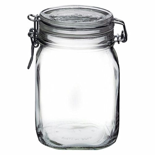 Clear glass jar with metal clamp.