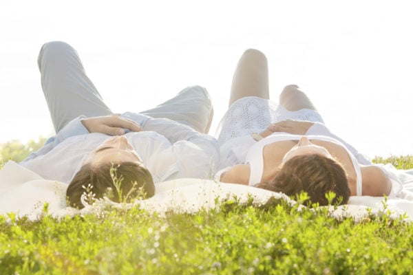 Couple on Romantic Picnic Lying on Blanket on Grass