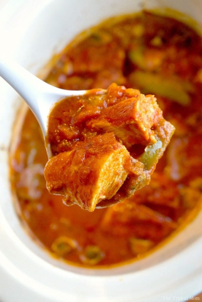 chicken cacciatore on spoon above bowl