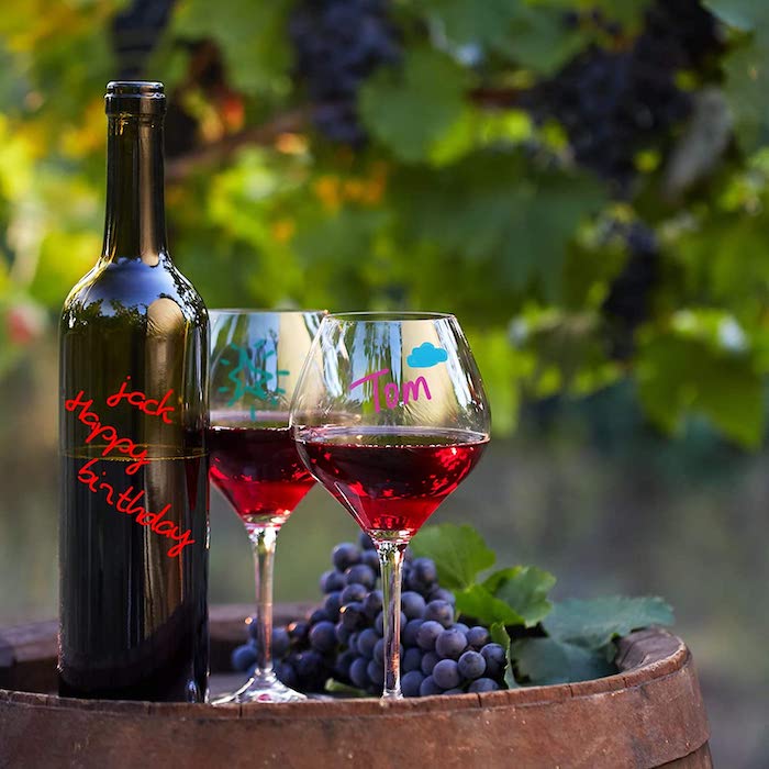 messages written on wine glasses with markers