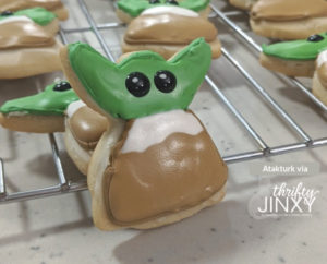 Frosted Baby Yoda Cookie on cooling rack.