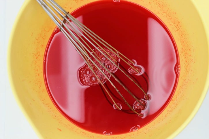 Mixing red Jell-O with hot water for Jell-O Hearts Recipe.