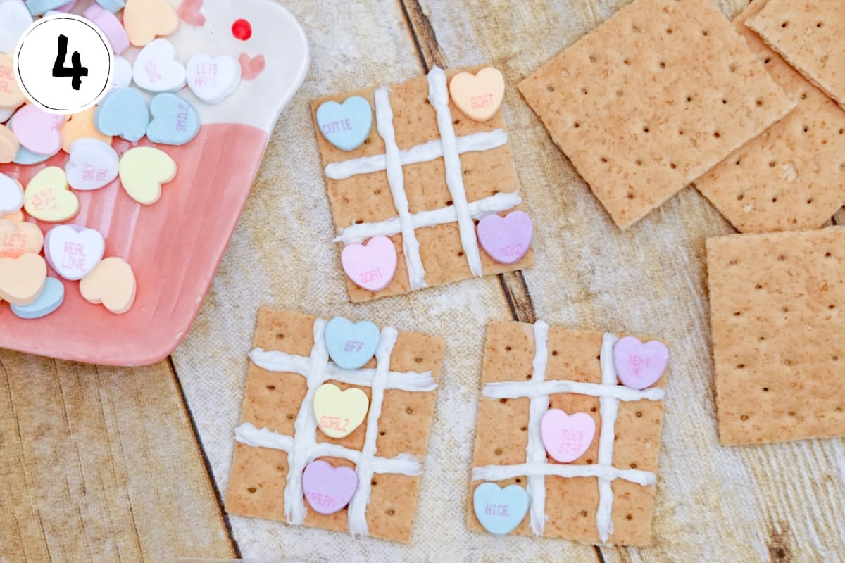 Playing Tic Tac Toe Grid on Graham Crackers with Conversation Hearts.