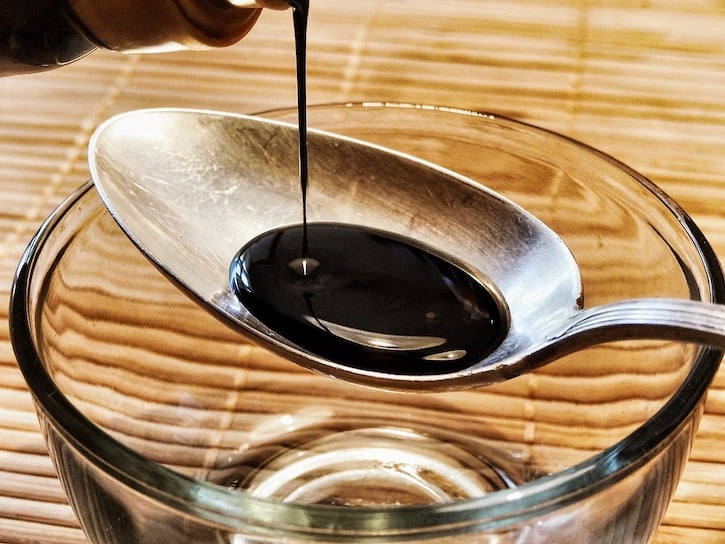 soy sauce on spoon