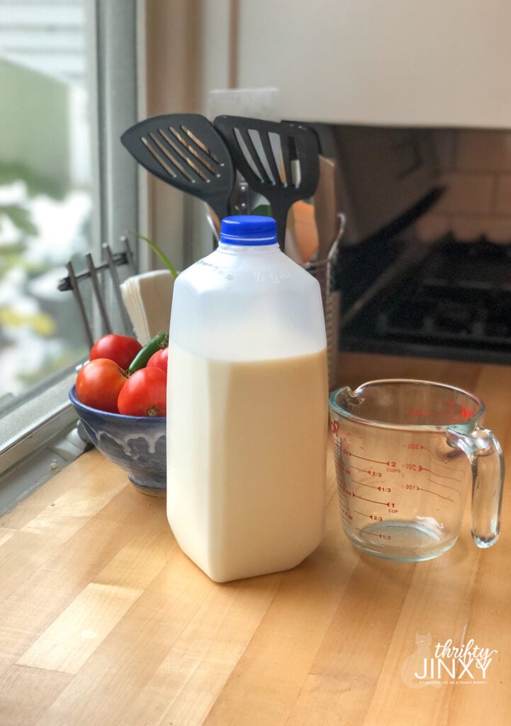 Milk in Jug with Measuring Cup