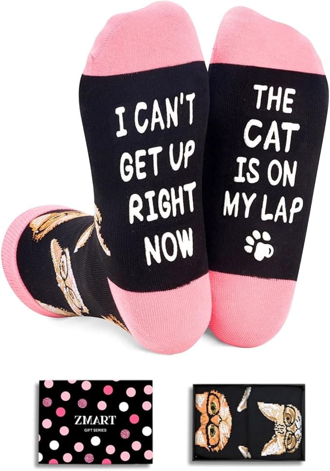 Pink and black socks with I Can't Get Up the Cat Is on My Lap written on the soles.