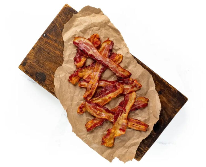 cooked bacon on brown paper