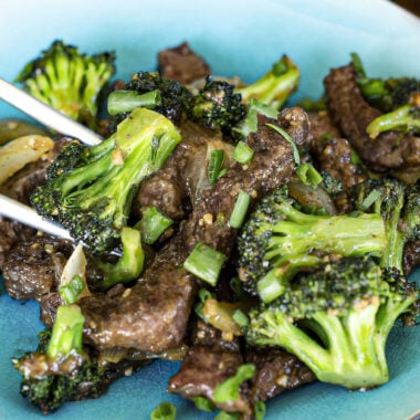 plate of beef and broccoli with chopsticks
