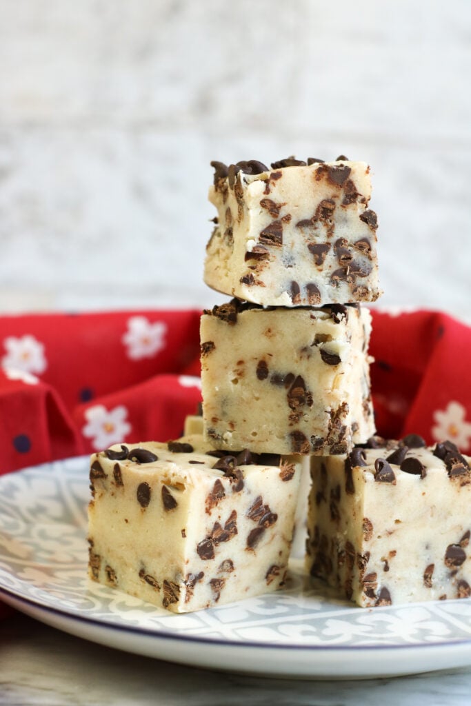 Chocolate Chip Cookie Dough Fudge in a stack on a plate 