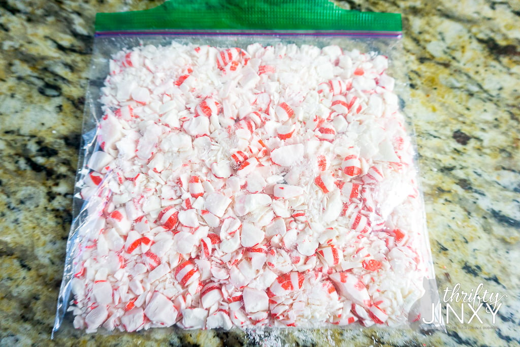 crushing peppermint candies in ziploc bag using rolling pin