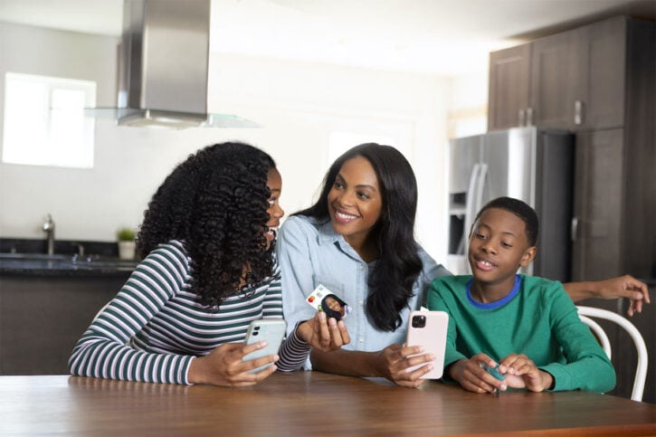 Mother and Children with Greenlight Debit Card