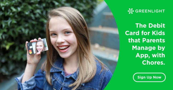 Girl holding Greenlight Debit Card for Kids