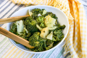 Panda Express Copycat Super Greens in bowl with wooden tongs for serving