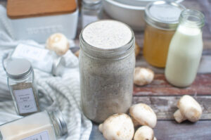 Homemade Condensed Cream of Mushroom Soup in Jar on Table with Ingredients