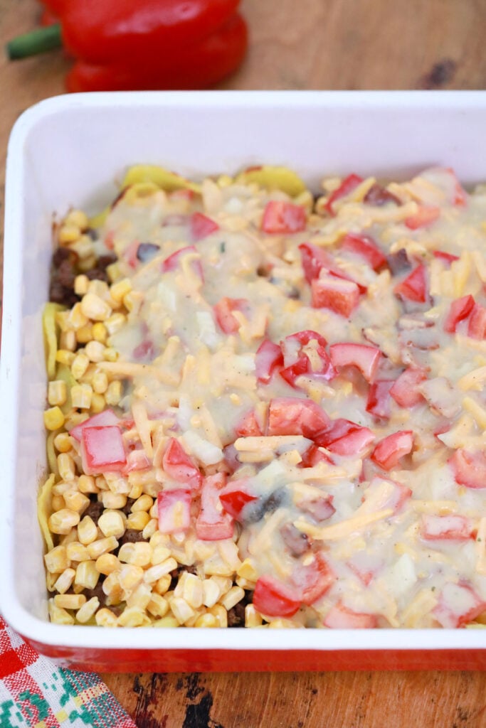 adding cream of mushroom soup mixture to casserole