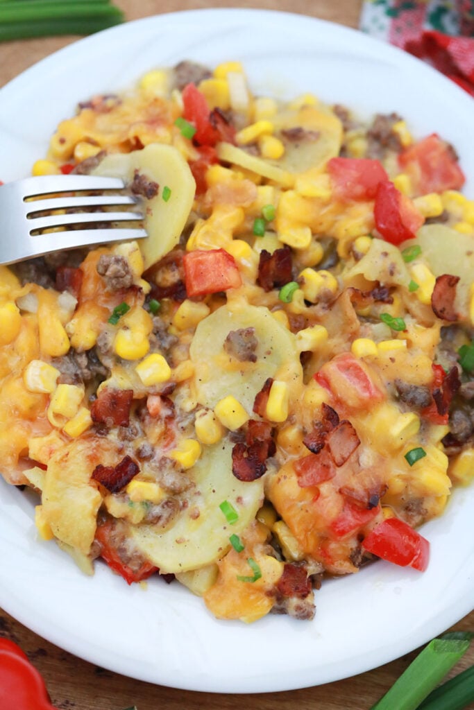 hamburger and potato casserole with veggies and cheese on plate