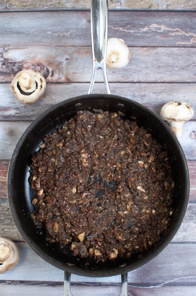 sauteeing mushrooms in a skillet with butter
