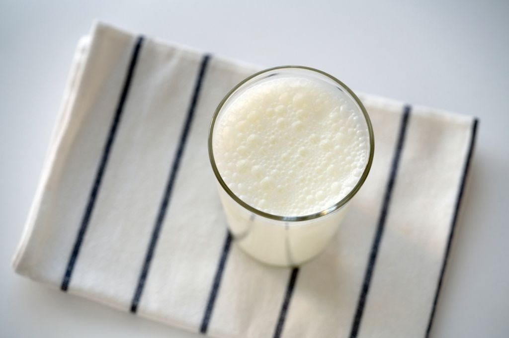 buttermilk in glass on towel
