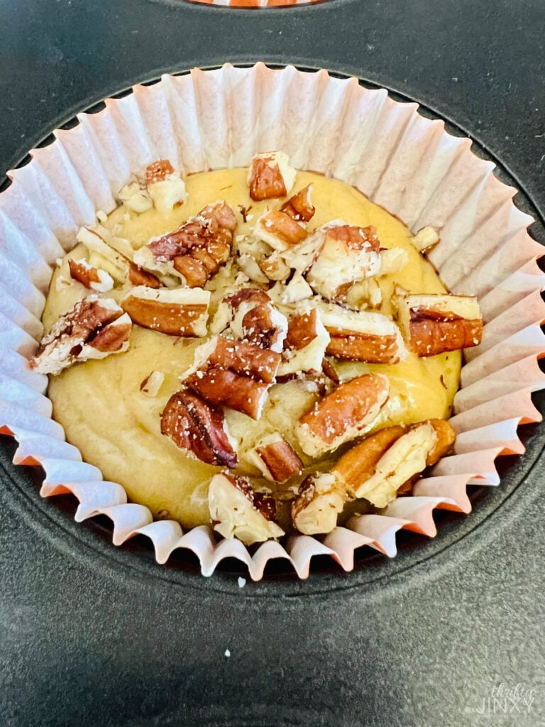 Pecan Pie Muffin Batter Topped with Chopped Pecans