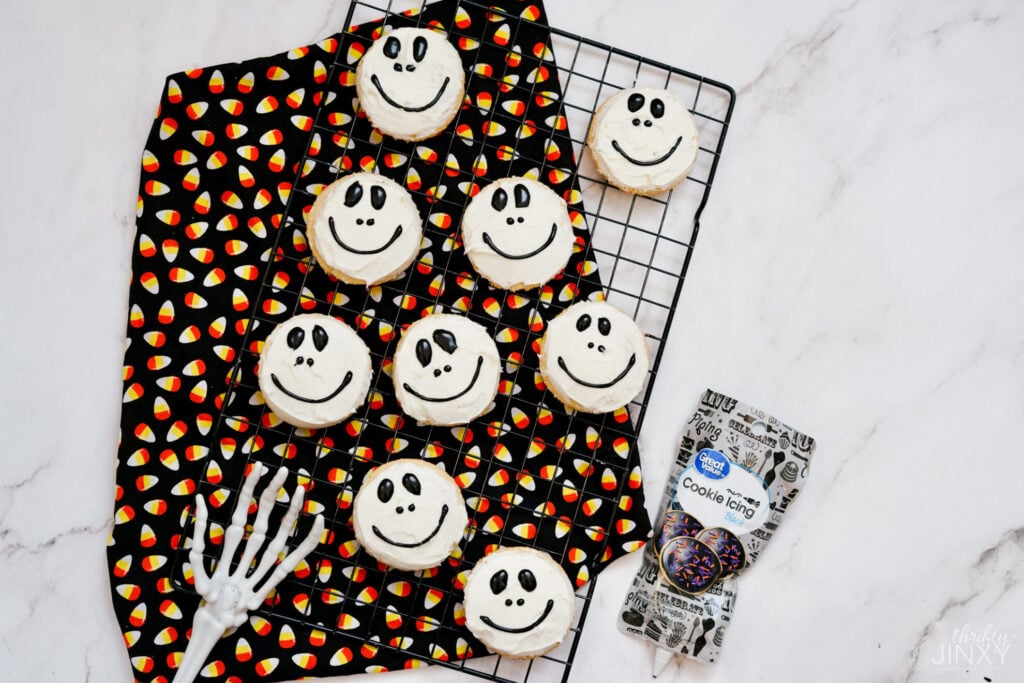 drawing mouth on Jack Skellington Cookies with black icing