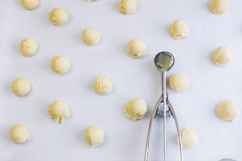 using a cookie scoop to make the cookie dough balls 