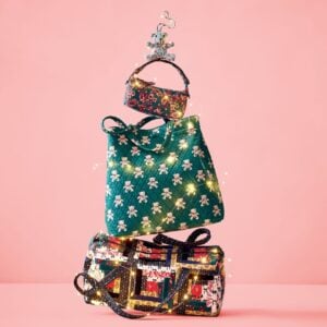 Vera Bradley bags stacked into Christmas Tree formation with lights.