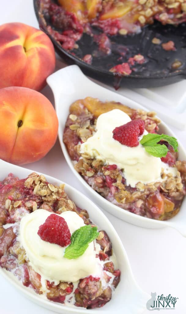 Skillet Peach Raspberry Crisp in serving dishes with ice cream