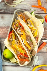 Sheet Pan Steak Fajitas in flour tortillas.