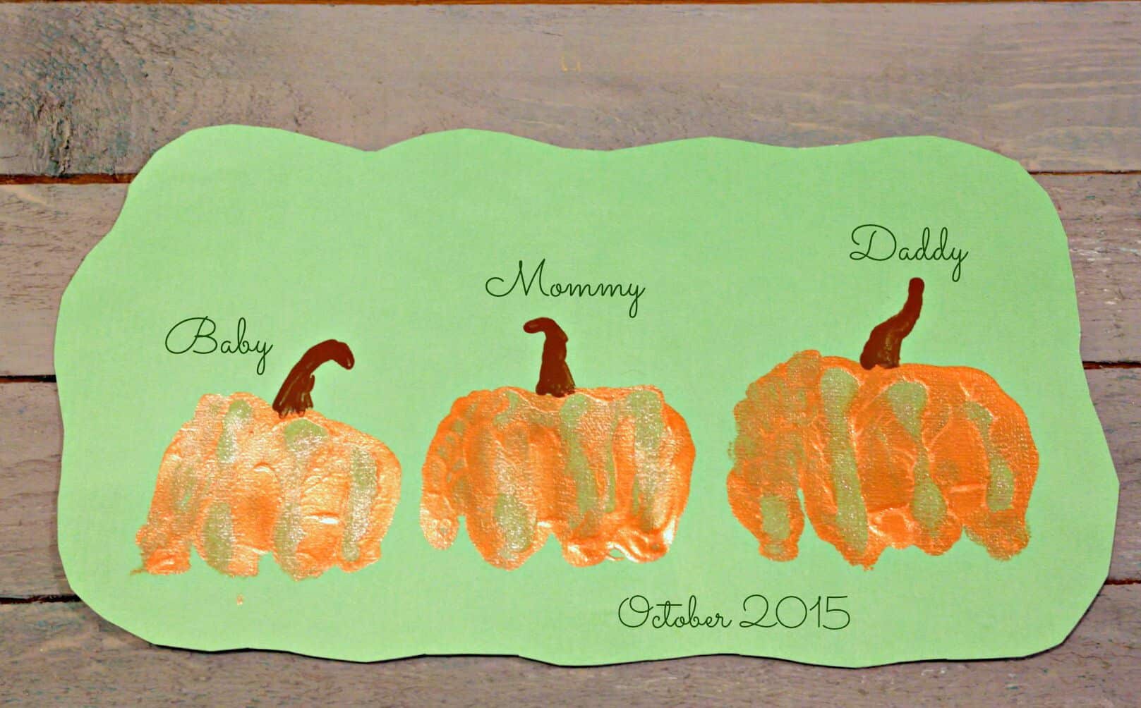 fist pumpkins art project with baby, mother and father fist prints turned into pumpkins.