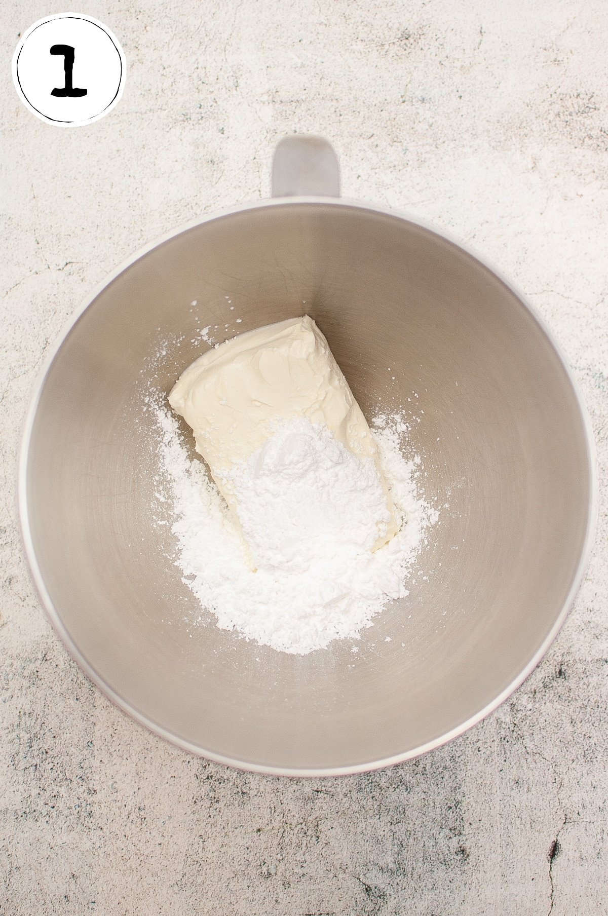 Combining Cream Cheese and Powdered Sugar.