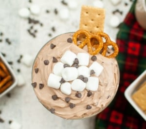 Hot Cocoa Dip with marshmallows served with graham crackers and pretzels.