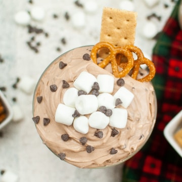 Hot Cocoa Dip with marshmallows served with graham crackers and pretzels.
