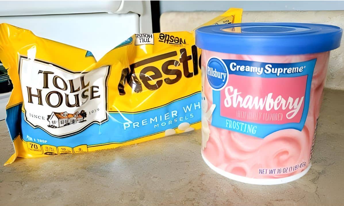 Bag of white chocolate morsels and can of strawberry frosting.