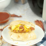 taco bell crunch breakfast crunch wrap on a white plate
